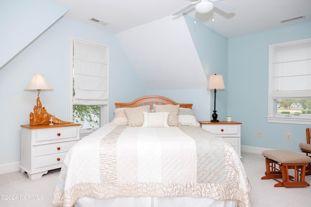 bedroom featuring vaulted ceiling, baseboards, visible vents, and light colored carpet