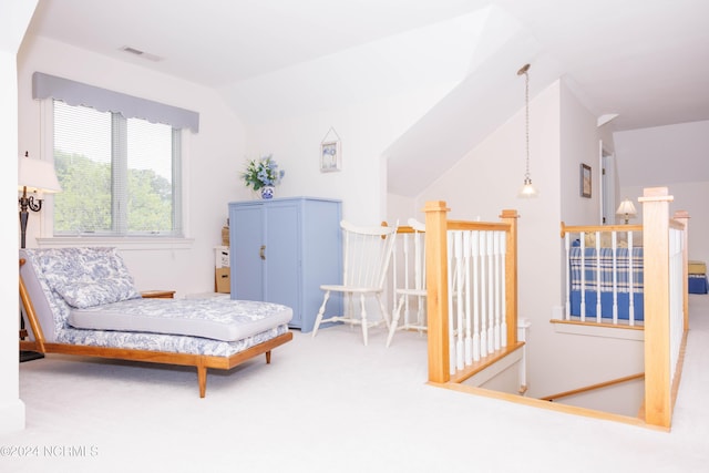 sitting room featuring lofted ceiling, carpet floors, and visible vents