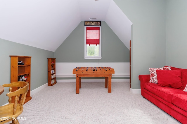 recreation room with vaulted ceiling, carpet floors, and baseboards