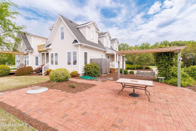 exterior space featuring a patio, a shingled roof, and a pergola