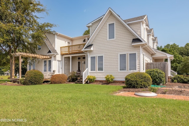 view of front of property featuring a balcony, crawl space, a pergola, and a front yard