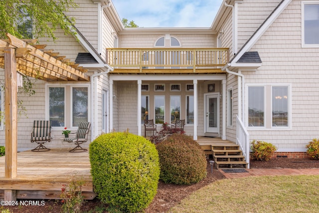 exterior space with a balcony, crawl space, a pergola, and a wooden deck