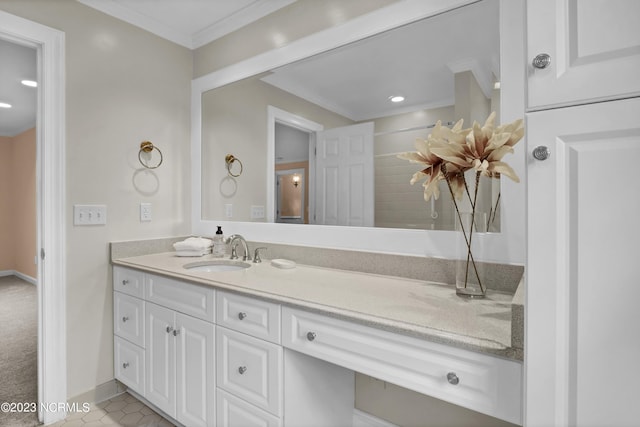 bathroom featuring tile patterned flooring, crown molding, and vanity