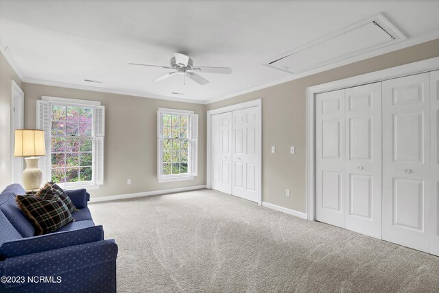 sitting room featuring ceiling fan, ornamental molding, and carpet floors