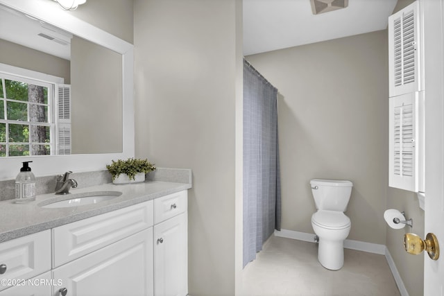 bathroom with vanity, tile patterned floors, and toilet