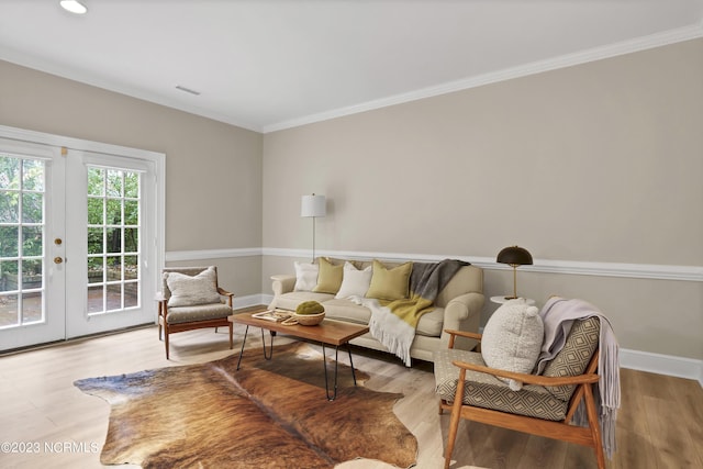 living room with french doors, ornamental molding, and hardwood / wood-style floors