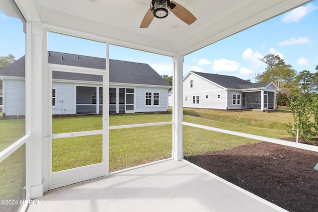 unfurnished sunroom with ceiling fan