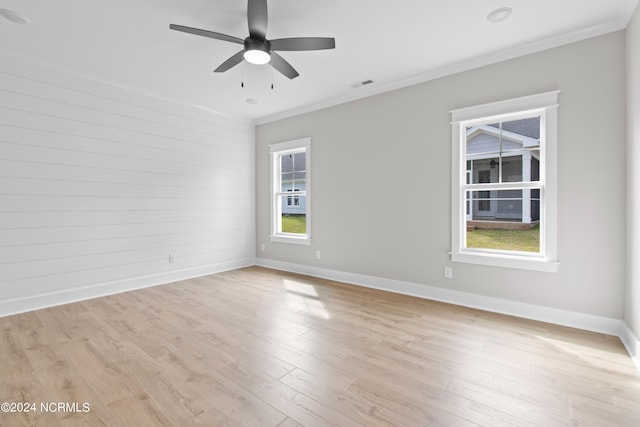 spare room featuring ceiling fan, ornamental molding, and light hardwood / wood-style flooring