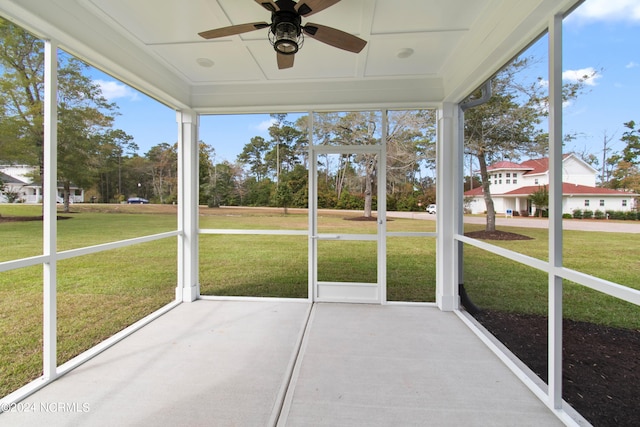 unfurnished sunroom featuring ceiling fan