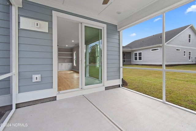 unfurnished sunroom featuring ceiling fan