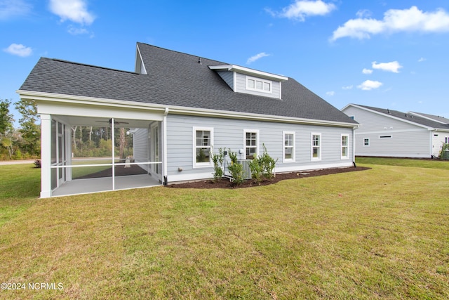 back of property featuring a patio, a sunroom, and a lawn