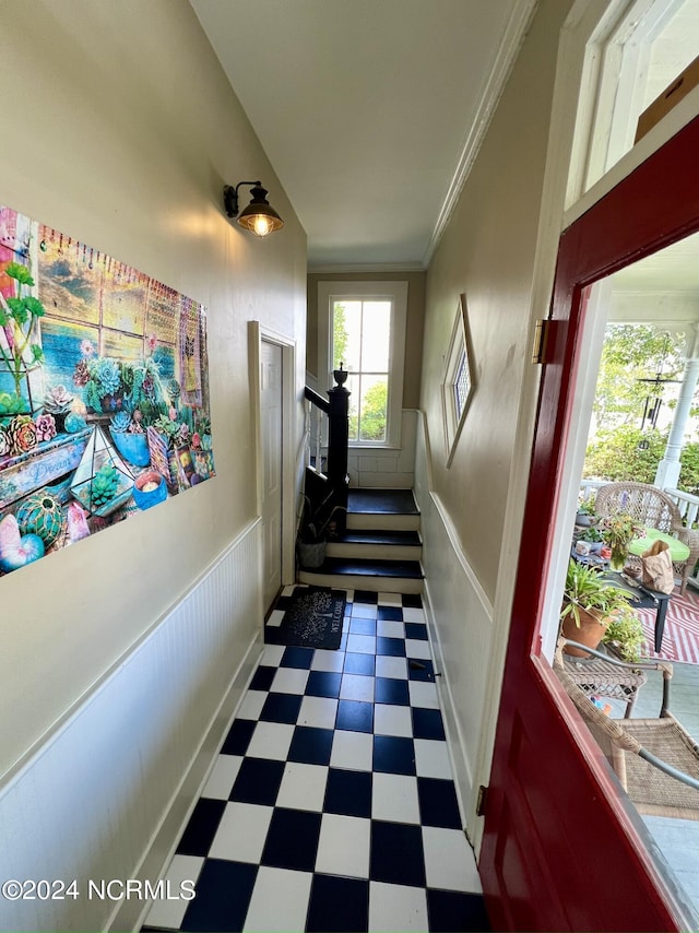 corridor featuring crown molding and dark tile patterned floors