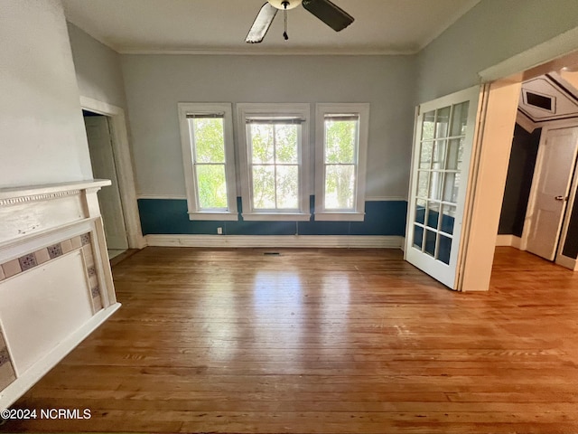 unfurnished living room featuring hardwood / wood-style flooring and ceiling fan