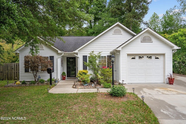 ranch-style home featuring a garage and a front lawn