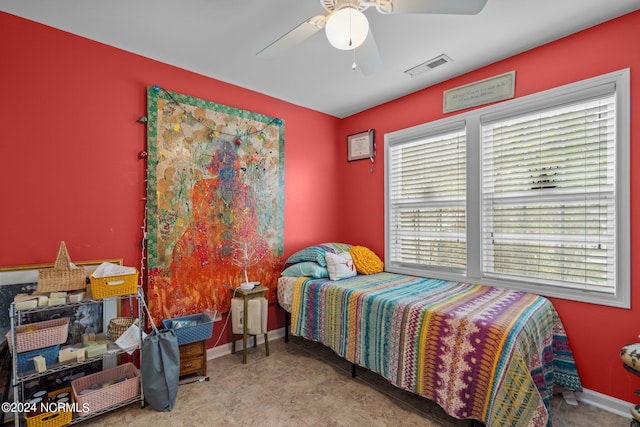 bedroom featuring multiple windows, light tile patterned floors, and ceiling fan