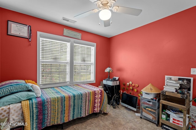 tiled bedroom featuring ceiling fan