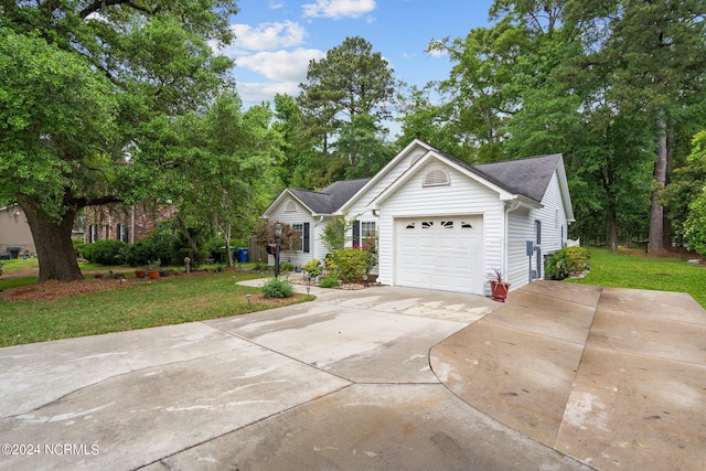 view of front of home with a garage and a front lawn