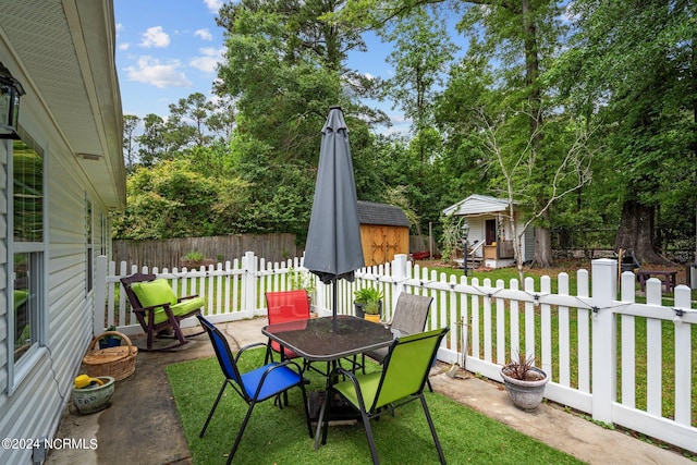 view of patio featuring a storage shed