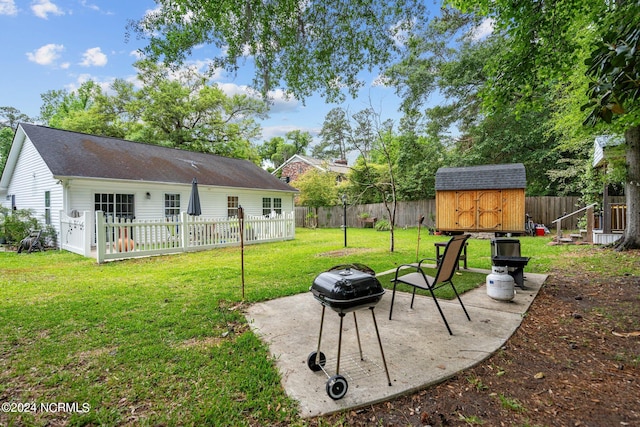 view of yard featuring a patio area and a storage shed