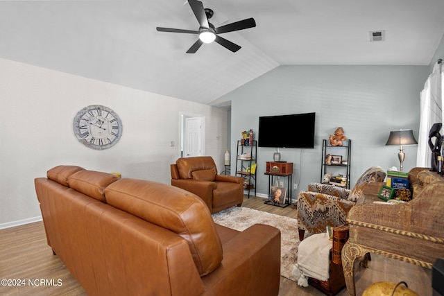 living room with ceiling fan, light hardwood / wood-style flooring, and lofted ceiling