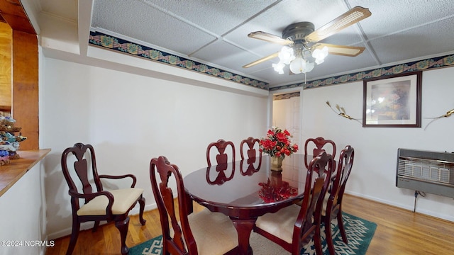 dining space with ceiling fan and light hardwood / wood-style flooring