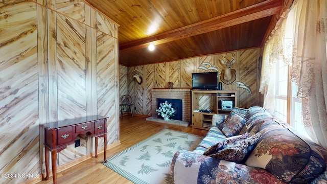 living room featuring beamed ceiling, hardwood / wood-style flooring, wooden walls, a brick fireplace, and wood ceiling