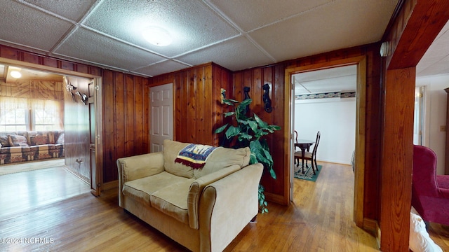 living area featuring wood walls and hardwood / wood-style floors