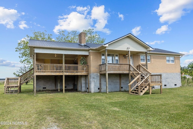 rear view of property with a lawn