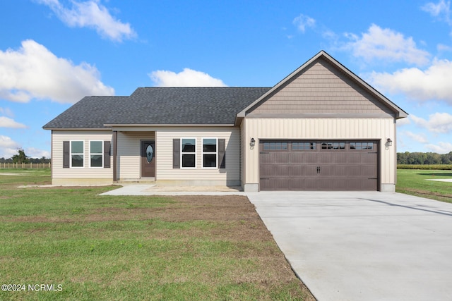 view of front of house featuring a garage and a front lawn