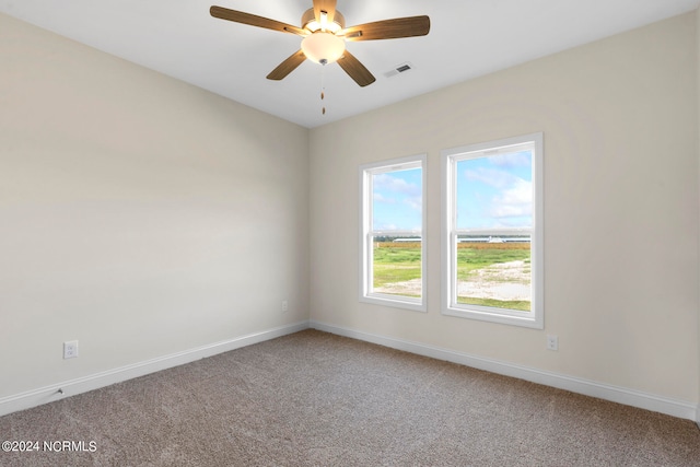 carpeted spare room featuring ceiling fan