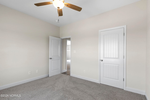 unfurnished bedroom with carpet, ceiling fan, and a closet