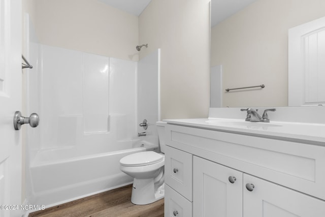 full bathroom with shower / bathtub combination, hardwood / wood-style floors, vanity, and toilet