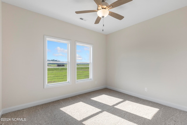 carpeted spare room with ceiling fan