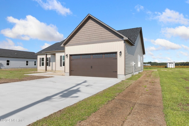 view of front of property with a front yard and a garage