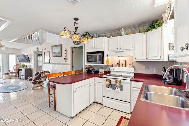 kitchen with decorative light fixtures, light tile flooring, stainless steel microwave, sink, and white range with electric stovetop