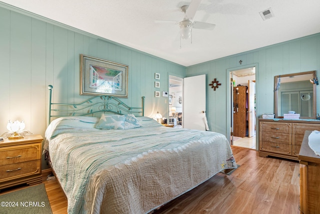 bedroom with wood-type flooring and ceiling fan