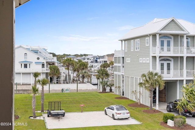 view of home's community featuring a lawn