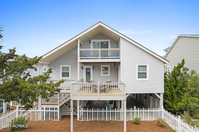 view of front of property with a deck and a balcony