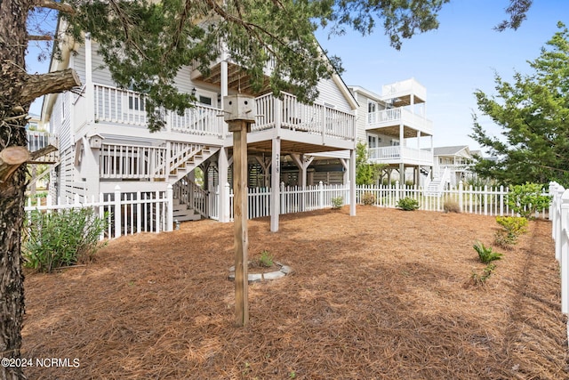 rear view of property featuring a deck