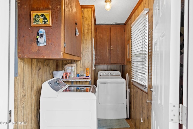 laundry area featuring independent washer and dryer and cabinets