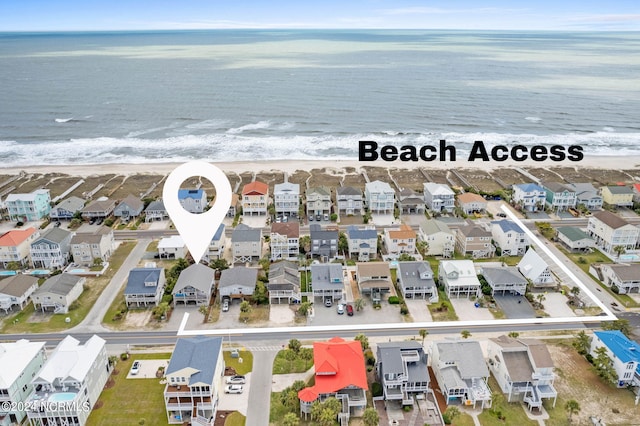 drone / aerial view featuring a beach view and a water view