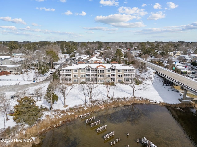 snowy aerial view featuring a water view