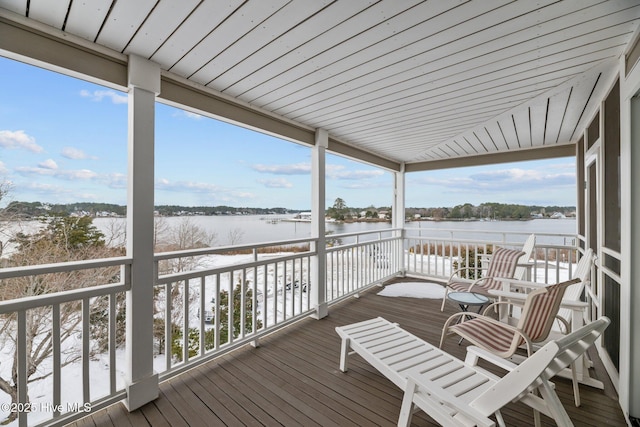 snow covered deck with a water view