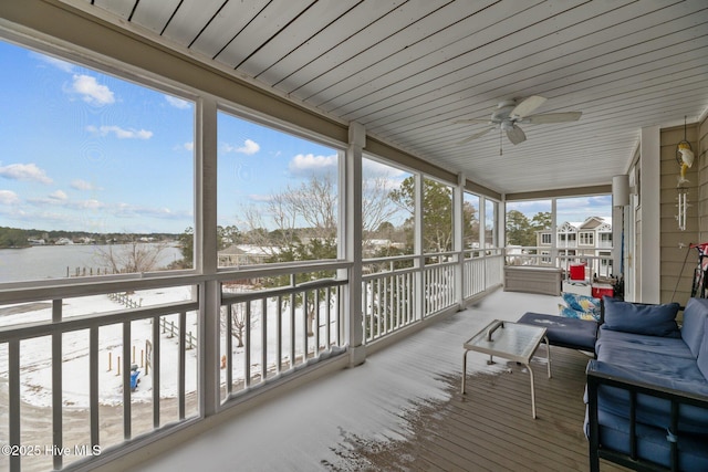 sunroom featuring a water view and a healthy amount of sunlight