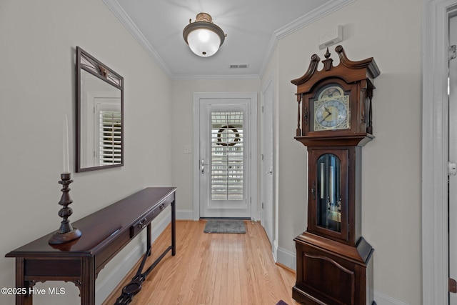 foyer featuring light hardwood / wood-style flooring and ornamental molding