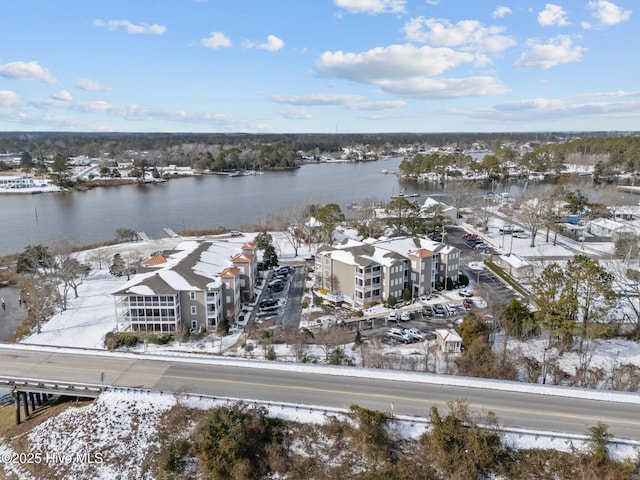 snowy aerial view with a water view