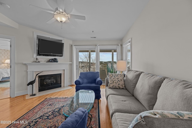 living room featuring lofted ceiling, hardwood / wood-style floors, and ceiling fan