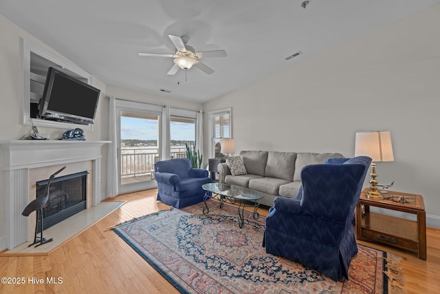 living room featuring ceiling fan and light wood-type flooring