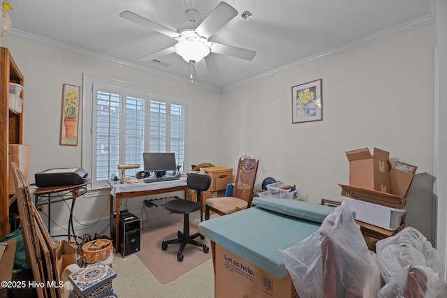 carpeted home office featuring crown molding and ceiling fan