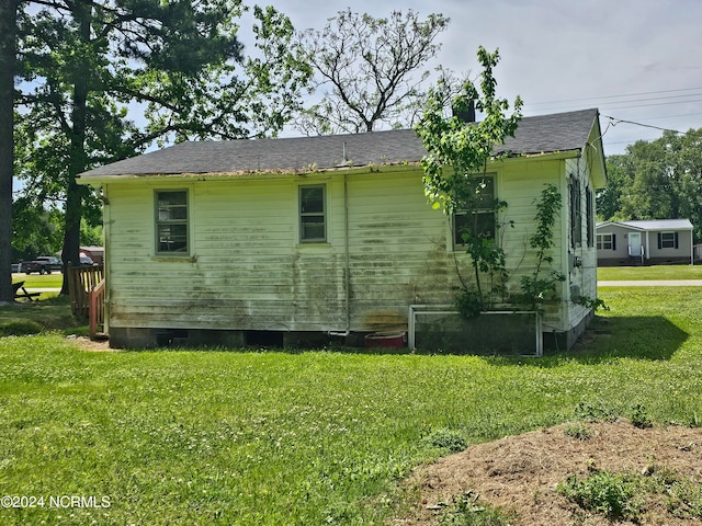 view of side of home featuring a lawn